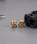 Premium 48Pcs Brass M4 Heat Set Threaded Inserts For 3D Printing With Knurled Design next to a 3D printed black part.