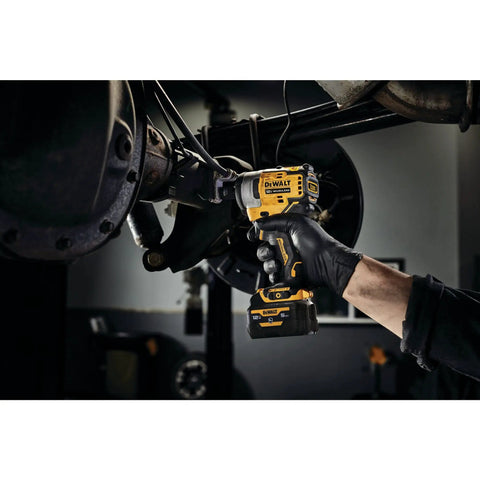 12V Max 3/8 Inch Cordless Impact Wrench Kit delivering Hella tight torque used for automotive repairs in a garage.
