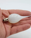 Hand holding Warm 5 Watt Silicone Dipped Candle Lamp Bulb with E12 Candelabra Base.
