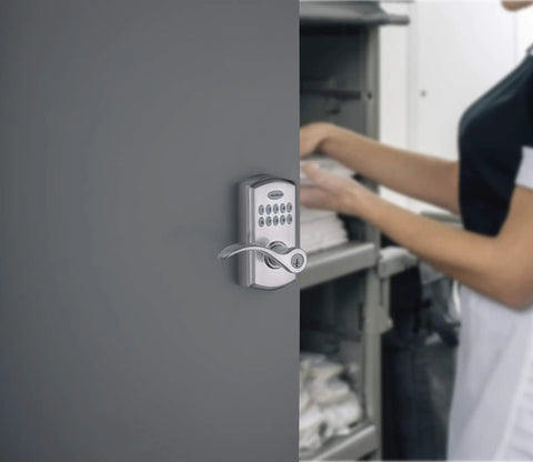 SmartCode 955 Pembroke 10 Button Keypad Electronic Lever Lock installed on a busy door, satin chrome finish, keyless entry