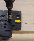 Close-up of Ultimate Cabinet Jig Bundle For DIYers with Cabinet Hardware Jig on wooden board in use.
