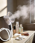 Facial steamer releasing steam with Silicone Steamer Tube 39 Inch Heat Resistant Steam Hose on table with beauty products