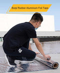 Person applying Heavy Duty Self Sealing Asphalt Tape With Aluminum Foil Backing Waterproof Bitumen Roll on roof surface.