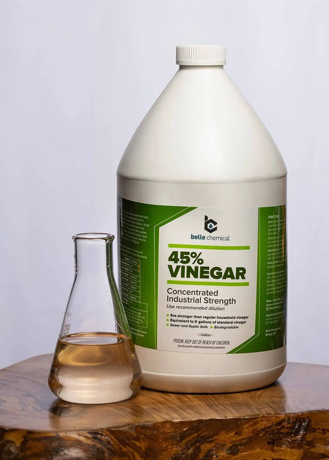 Industrial Strength 45 Percent Pure Vinegar Concentrate For Heavy Duty Cleaning And Degreasing, 1 Gallon Bottle next to glass container