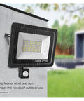 Led Pir Motion Sensor Led Flood Light Ac220 100W 50W 30W Outdoor Ip66 Waterproof Projector Spotlight Led Exterior Street Light for Court,Garden,Warehouse，30w-30，30w-3000K WARM LIGHT_WHITE SHELL mounted on wall, displaying wet surface with motion sensor.