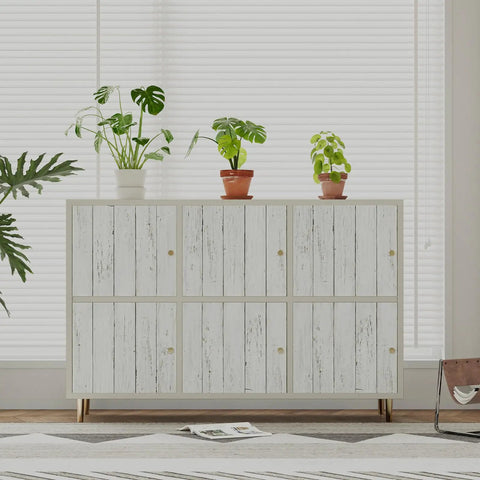 Cabinet with white gray wood peel and stick wallpaper and plants on top
