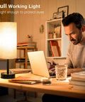 Man working at desk with Set Of 2 Fully Dimmable Bedside Lamps With USB C Charging Port And Built In USB Ports And Outlets, Black Base.