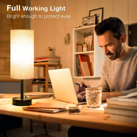 Man working at desk with Set Of 2 Fully Dimmable Bedside Lamps With USB C Charging Port And Built In USB Ports And Outlets, Black Base.