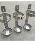 Three heavy duty stainless steel gas cylinder holder floor mount racks with welded hinges and one-piece bases for stable storage.