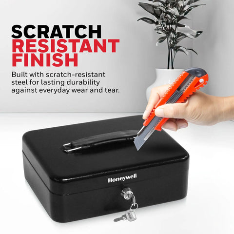 Compact Cash Box With Removable Money Tray And Under Tray Storage Five Coin Slots Durable Metal Safe With Key Lock Ideal For Home Office Black 0.14 Cu Ft Saving Money Lock Box shown in use with scratch test.