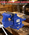 Heavy Duty 6 Inch Bench Vise With Jaw Pads And Anvil For Woodworking Drilling And Pipe Cutting 360 Degree Swivel Locking Base 4500 Lbs Clamping Force Beast Mode Strength shown in workshop with hammer and metal sheet