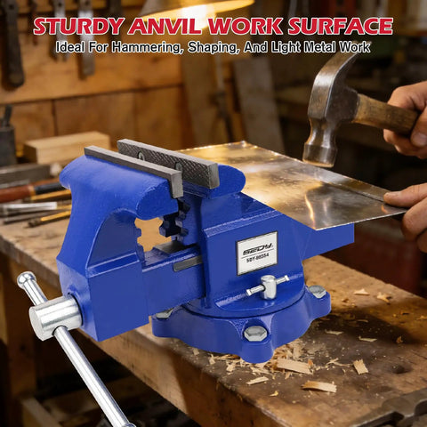 Heavy Duty 6 Inch Bench Vise With Jaw Pads And Anvil For Woodworking Drilling And Pipe Cutting 360 Degree Swivel Locking Base 4500 Lbs Clamping Force Beast Mode Strength shown in workshop with hammer and metal sheet