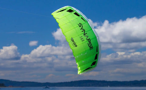 Synapse 140 Dual-Line Parafoil Kite in Cilantro, flying against blue sky and clouds, no frame parts, easy setup, durable for kids and adults