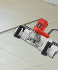 Built Tough Tile Chamfering Machine Featuring A 1200W Corded Motor And Splash Free Cooling System For Quick 43 Degree Cutting At 13000RPM No Sweat Beveling Edger that cuts tiles on a smooth surface.