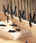Heavy Duty 4.5-Inch Spring Clamps 20 Pack Pro Grade Nylon Construction With Removable Orange Jaw Pads securing wood pieces