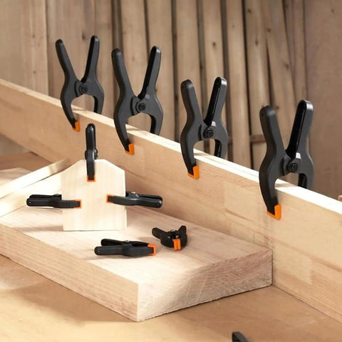 Heavy Duty 4.5-Inch Spring Clamps 20 Pack Pro Grade Nylon Construction With Removable Orange Jaw Pads securing wood pieces