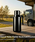 Portable Stainless Steel 12V 24V Car Kettle With Heat Preservation Dual Wattage Settings For Keeping Your Brew Piping Hot On Backroads on a wooden table outside.