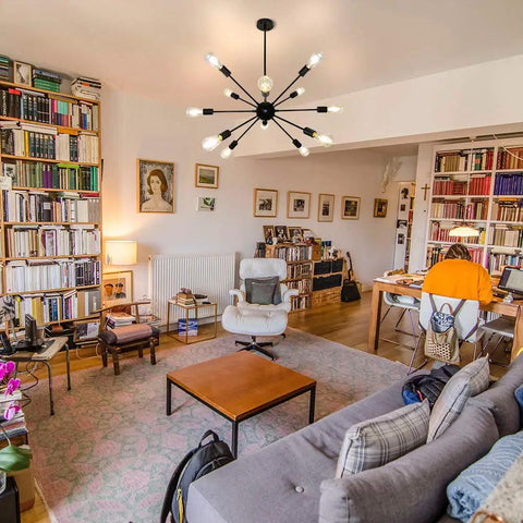 Sputnik Style Ceiling Light Fixture With 12 Lights Black Chandelier in modern living room with bookshelves and seating area
