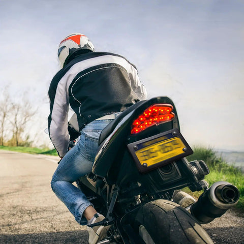 Rider on motorcycle with Two Pack Stainless Steel Motorcycle License Plate Frames In Black Finish Heavy Duty Metal Plate Cover.