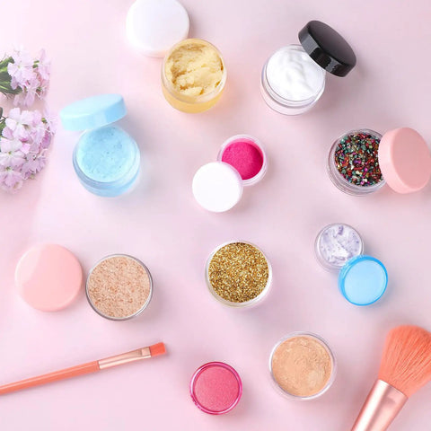 10 Piece Clear Acrylic Makeup Travel Jars With Lids In 0.11 Oz 0.18 Oz 0.35 Oz 0.53 Oz And 0.7 Oz Sizes Plus 5 Mini Spatulas on pink surface