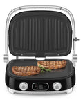 SMEG MGF01 Retro Countertop Electric Grill and Panini Press With Swappable Plates For Waffles, Burgers, And Steak showcasing grilling steaks.