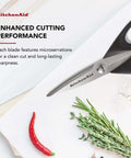 All Purpose Kitchen Shears with Protective Sheath, Rust Resistant Stainless Steel Blades, Micro Serrated Edges, Soft Grip Comfort Handle shown cutting herbs