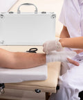 Built Tough Aluminum Alloy Work Crate With Cushion Grip Bail And Quick Release Cover For Grease Monkey Multi Layer Tool Sorting Or On The Road Health Supply Tote with bandaged arm and medical professional.