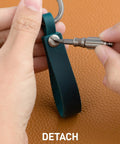 Top Shelf Crazy Horse Leather EDC Keychain Strap With Aerospace Titanium Key Ring For Car Keys being detached with a tool.