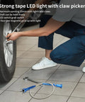 Extendable Magnetic Pickup Tool With Flexible Telescopic Pole And Bright LED Light For Easy Retrieval Of Small Parts Around The House Or Car this blue flex shaft is used by a mechanic at a tire
