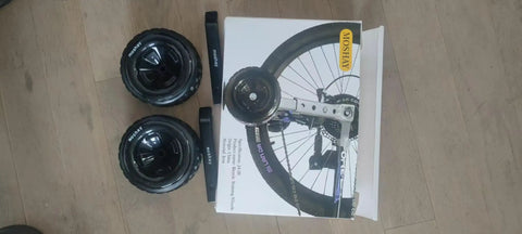 Training Wheels Set For 16 18 20 22 24 Inch Bikes With Steel Adjustable Bracket And Hardware Pack packaging on floor