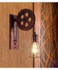 Absolutely Sick Industrial Wall Lamp With Vintage Pulley Handle Crafted From Heavy Wrought Iron Ideal For Barn Lofts And Man Caves With Super Cool Diffused Lighting, showcasing a rustic design with a warm glow.