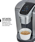 All In One Single Serve Coffee Maker With Strong Brew Power And Temperature Control, brushed silver finish dispensing hot water into a bowl.