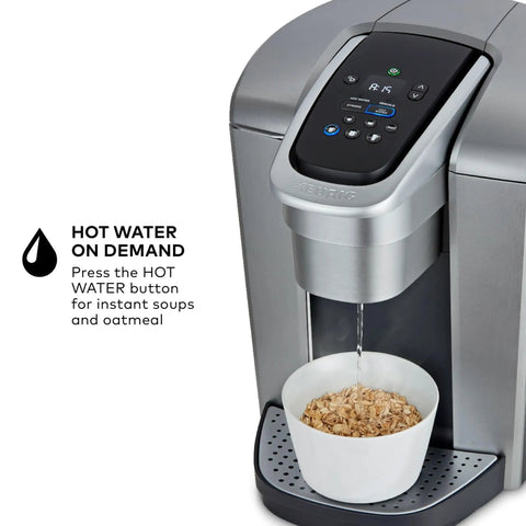 All In One Single Serve Coffee Maker With Strong Brew Power And Temperature Control, brushed silver finish dispensing hot water into a bowl.
