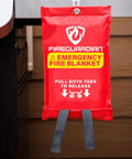 Red pouch of Emergency Fire Blanket 40 By 40 Inches, Woven Fiberglass Fire Shield hanging by a grill for safety use.