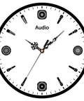 Close-up of white clock face with microphone and speaker icons as numbers.