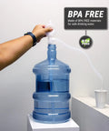 Heavy Duty Manual Siphon Hand Pump For Water And Fuel Transfer Featuring Flexible Hose in use with water cooler.