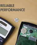 Top Shelf CR1616 3V Lithium Coin Cell Batteries 5 Pack Ready To Go Button Cells placed near a calculator.