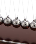 Close-up of metal balance balls on Newton's Cradle Desk Toy For Home Office Stress Relief With Metal Balance Balls Pendulum