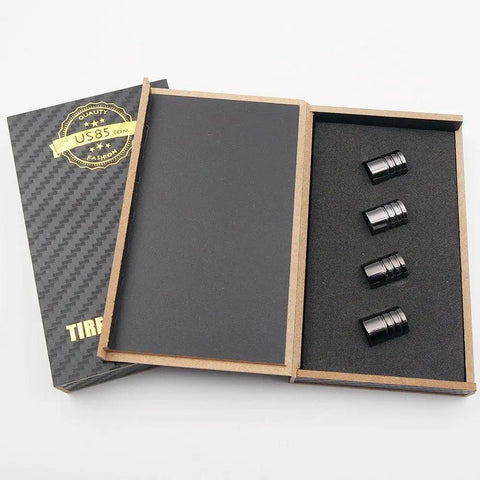 GMC Logo Emblem Valve Cap Set For Cars Four Pack Dope Carbon Fiber Look Black Chrome Wheel Tire Stem Covers Easy Install 8mm Valve Stem Fit Durable Auto Accessories Decor Gift in open box with four caps.