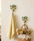 Vintage Flower Wall Hooks, Distressed Metal Coat Rack Set, Ace Farmhouse Entryway Organizer with a towel and a basket.