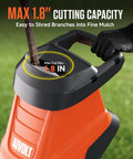 Electric Wood Chipper Shredder With 15 Amp Beast Power for branches up to 1.8 inches in use shredding a branch outdoors.