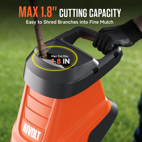Electric Wood Chipper Shredder With 15 Amp Beast Power for branches up to 1.8 inches in use shredding a branch outdoors.