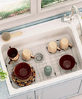 Heavy Duty Stainless Steel Kitchen Sink Grid And Protectors 26 By 14 Inches For Bottom Sink With Rear Drain Five Point One Inches Corner Radius in use as drying rack with dishes