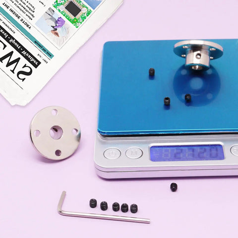 4 Piece 8mm Rigid Flange Shaft Coupling Kit With Set Screws And Included Wrench showcasing components on a digital scale
