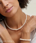 Woman wearing Must Have 14K Gold Akoya Pearl Necklace Bracelet Earrings Set With 18 Inch Princess Length For Women 7.5 To 8mm Round White Cultured Pearls High Luster Classic Elegant Jewelry Trio