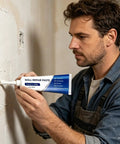 Man applying Easy Diy Drywall Repair Paste For Quick Fixes That Seals Cracks And Holes Tile Grout And Concrete Shower Floor Waterproof Sealant Wall Mending Paste Tube For Fast At Home Repairs And Restoration to wall crack