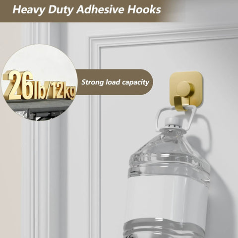 Heavy Duty Adhesive Wall Hooks In A Dope Four Pack, Stainless Steel Stick On Hangers With Badass Grip For Bathrooms And Kitchens, Waterproof And Super Fast To Put Up On Any Wall Or Door Without Drilling, Classic Gold Finish holds a water jug on a door.