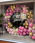Lit Happy Birthday Neon Sign LED Light with balloon arch decoration for birthday parties and home decor.