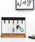 Solid Five Hook Table Key Holder With Torched Wood Base And Rustic Industrial Countertop Rack with keys and coins displayed.
