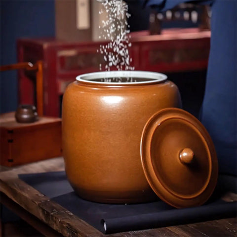 Hella Durable Ceramic Cereal And Rice Dispenser With Seamless Airtight Lid, brown ceramic jar with lid and grains pouring inside
